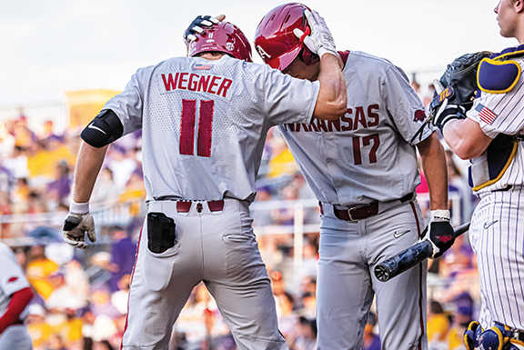 Arkansas Razorback hitter Jared Wegner celebrates his home run with Brady Slavens.